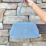 Light blue braided weave clutch handbag with removable strap and spacious interior