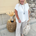 Wide-leg linen pants in a stone color with high-rise waist and pockets, styled for casual elegance.