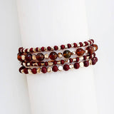 Four-stack beaded bracelet set with deep maroon, garnet, and cream beads of varying sizes