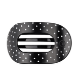 Black large flat round hair clip with a polka dot pattern.