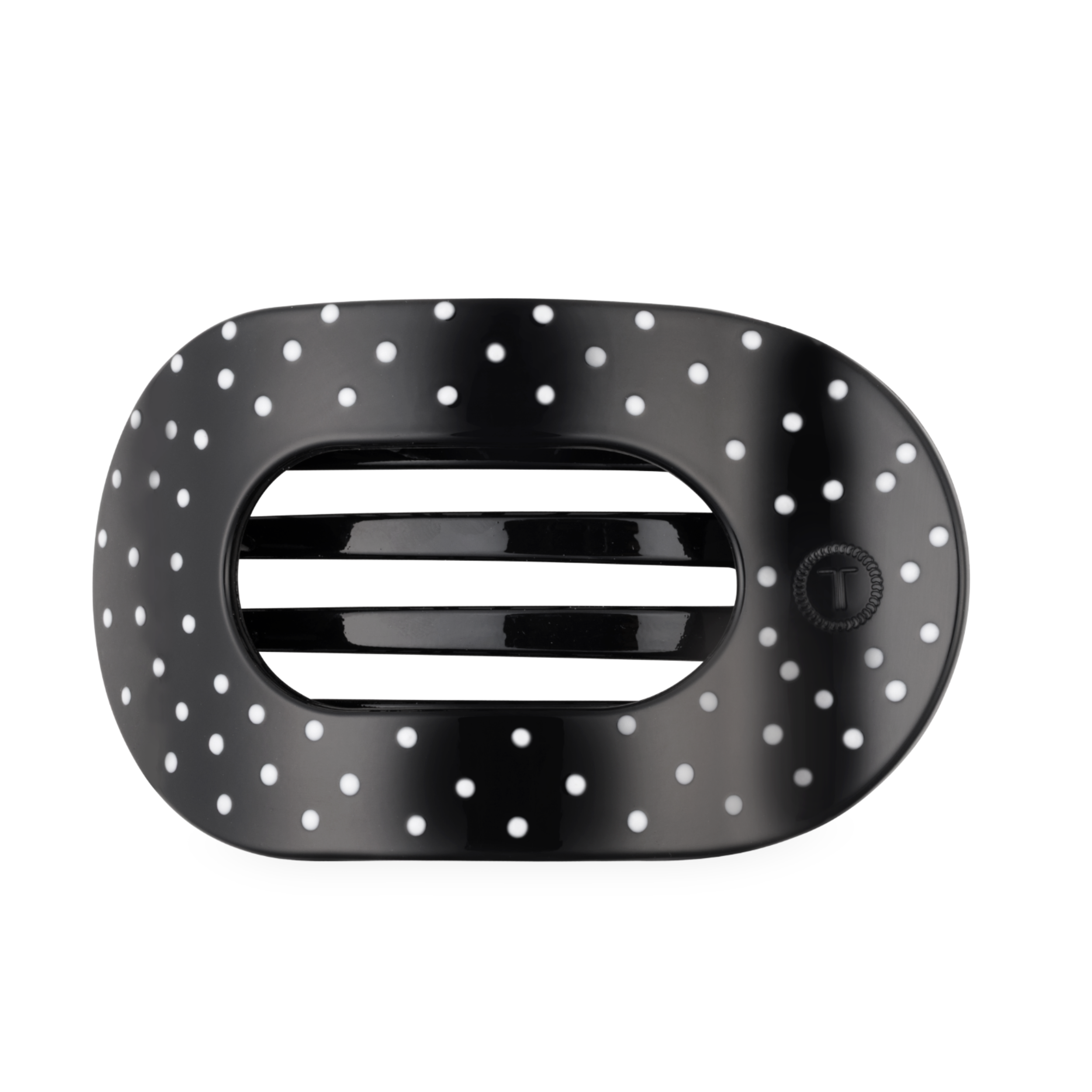 Black large flat round hair clip with a polka dot pattern.