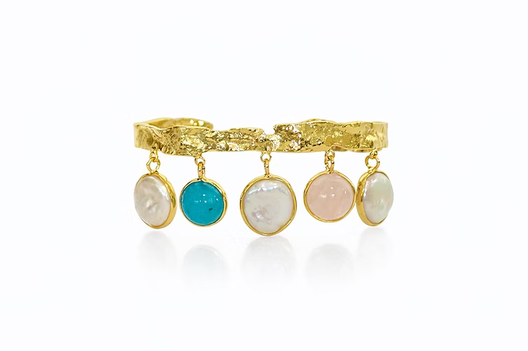 Gold cuff bracelet with cascading multi-colored stones