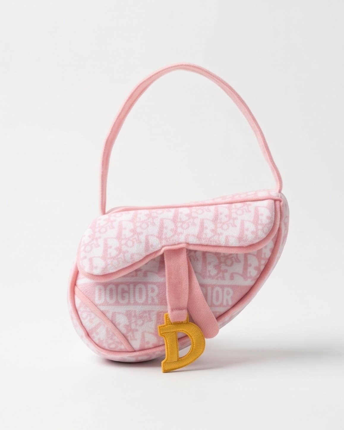 Pink plush saddle bag-shaped dog toy with a squeaker and crackle sound.