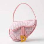 Pink plush saddle bag-shaped dog toy with a squeaker and crackle sound.