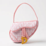Pink plush saddle bag-shaped dog toy with a squeaker and crackle sound.
