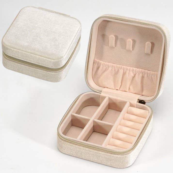 Beige velvet jewelry box organizer with top hooks, pouch, bottom compartments, and ring holder.