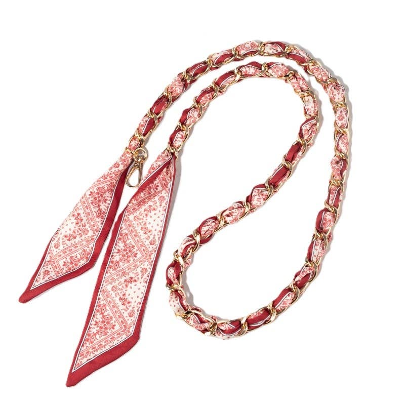 Garnet-bordered cream and light garnet Mediterranean tile scarf woven through gold chain bag strap with clasps.