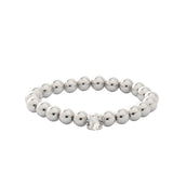 Silver-tone stretch bracelet with repeating metal beads and a single round crystal accent