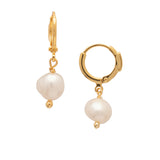 Bright gold-tone huggie hoop earrings with dangling round freshwater pearls from Sorrelli’s Modern Pearl Collection.