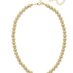 Bright gold necklace with repeating bead design and adjustable collarbone-length fit