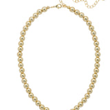 Bright gold necklace with repeating bead design and adjustable collarbone-length fit