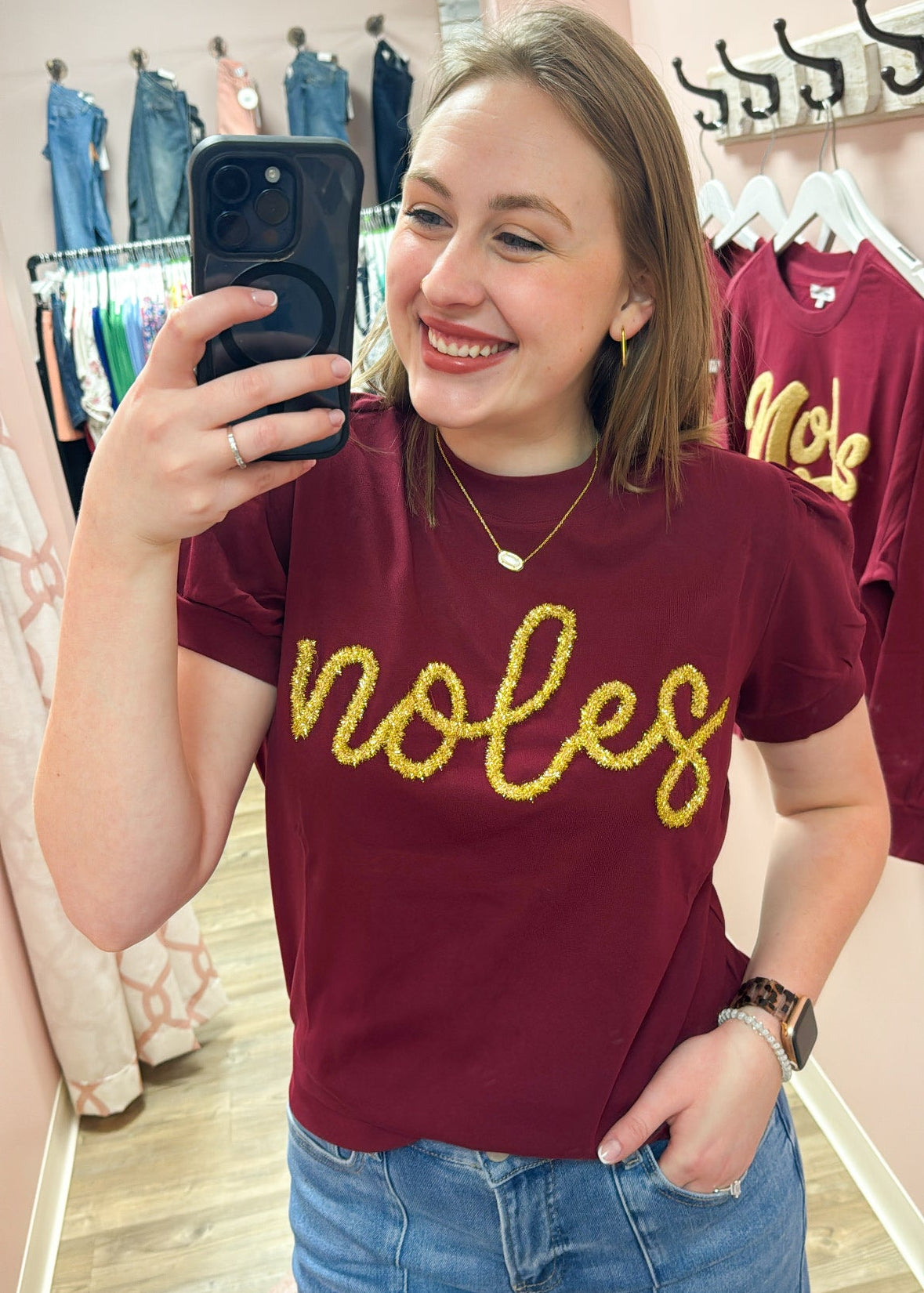 Lightweight garnet short-sleeve sweater top with gold tinsel “Noles” lettering across the chest