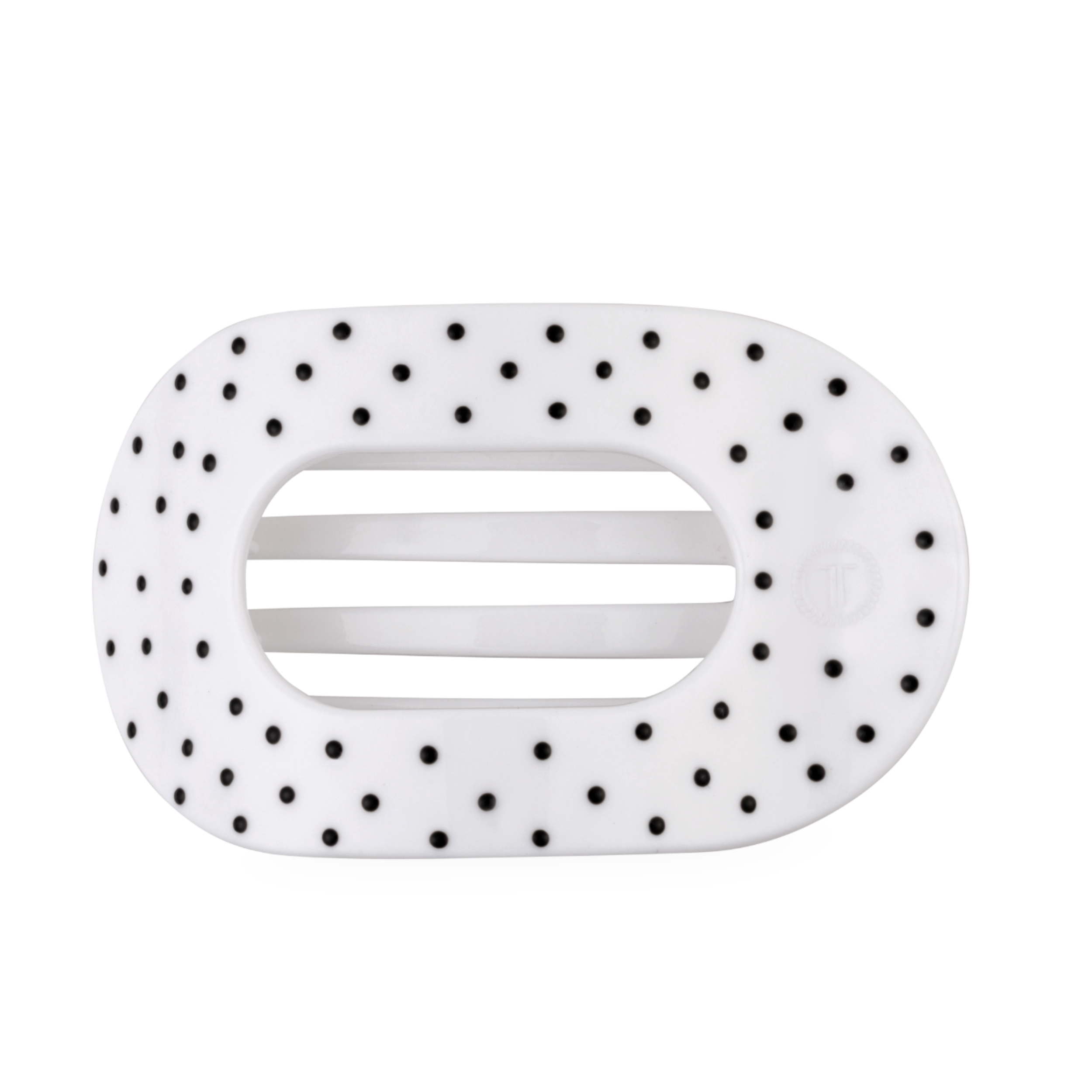 White large flat round hair clip with a black polka dot pattern.