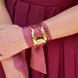 Garnet scarf bracelet with gold micro-pattern threaded through adjustable stainless steel cuff