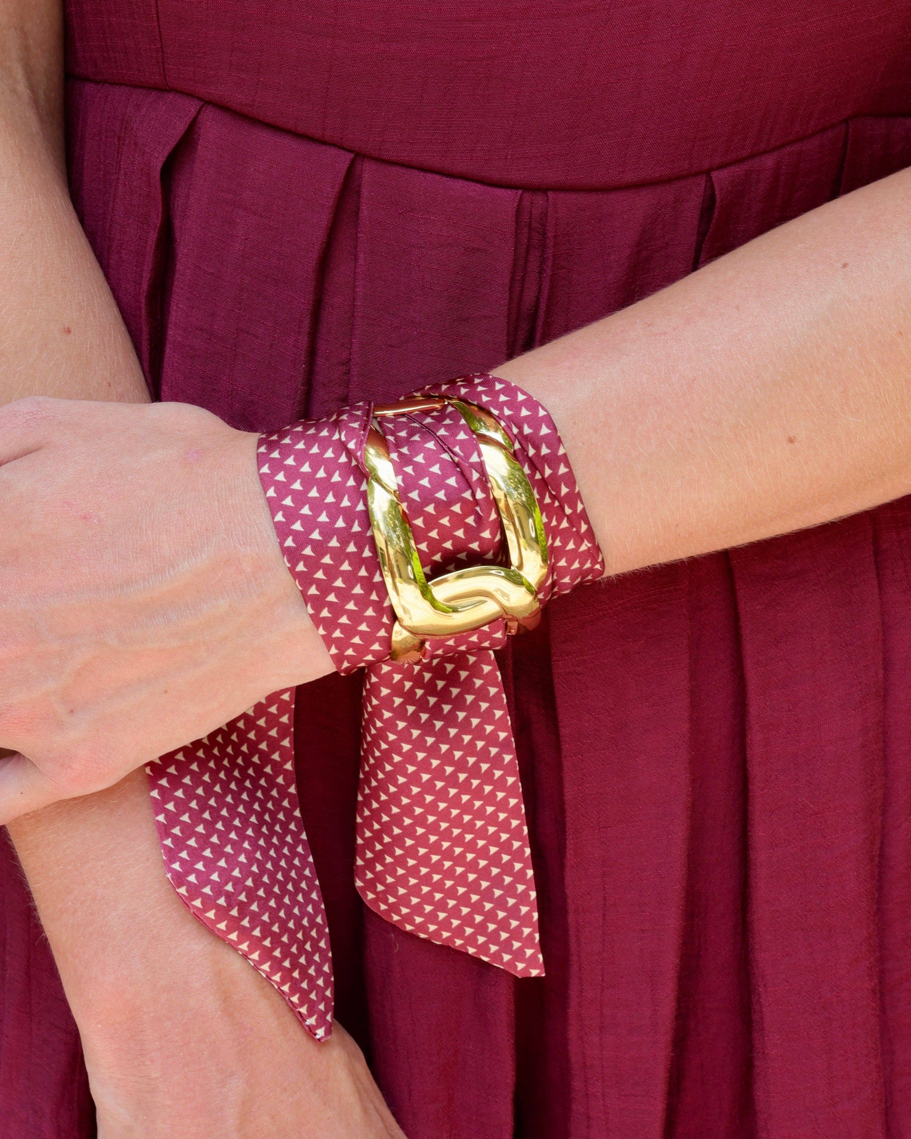 Garnet scarf bracelet with gold micro-pattern threaded through adjustable stainless steel cuff