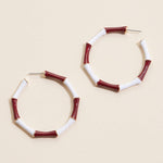 Garnet and white striped enamel hoop earrings with gold trim