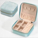 Blue velvet jewelry box organizer with top hooks, pouch, bottom compartments, and ring holder.