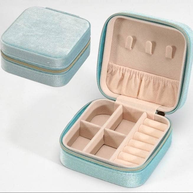 Blue velvet jewelry box organizer with top hooks, pouch, bottom compartments, and ring holder.
