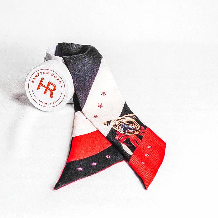 A small silk scarf featuring a University of Georgia bulldog wearing a scarf, styled with a gold-toned horseshoe charm for multiple ways to wear.