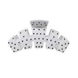 White medium claw clip with a black polka dot pattern.