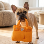Bright orange plush handbag-shaped dog toy with a built-in squeaker.
