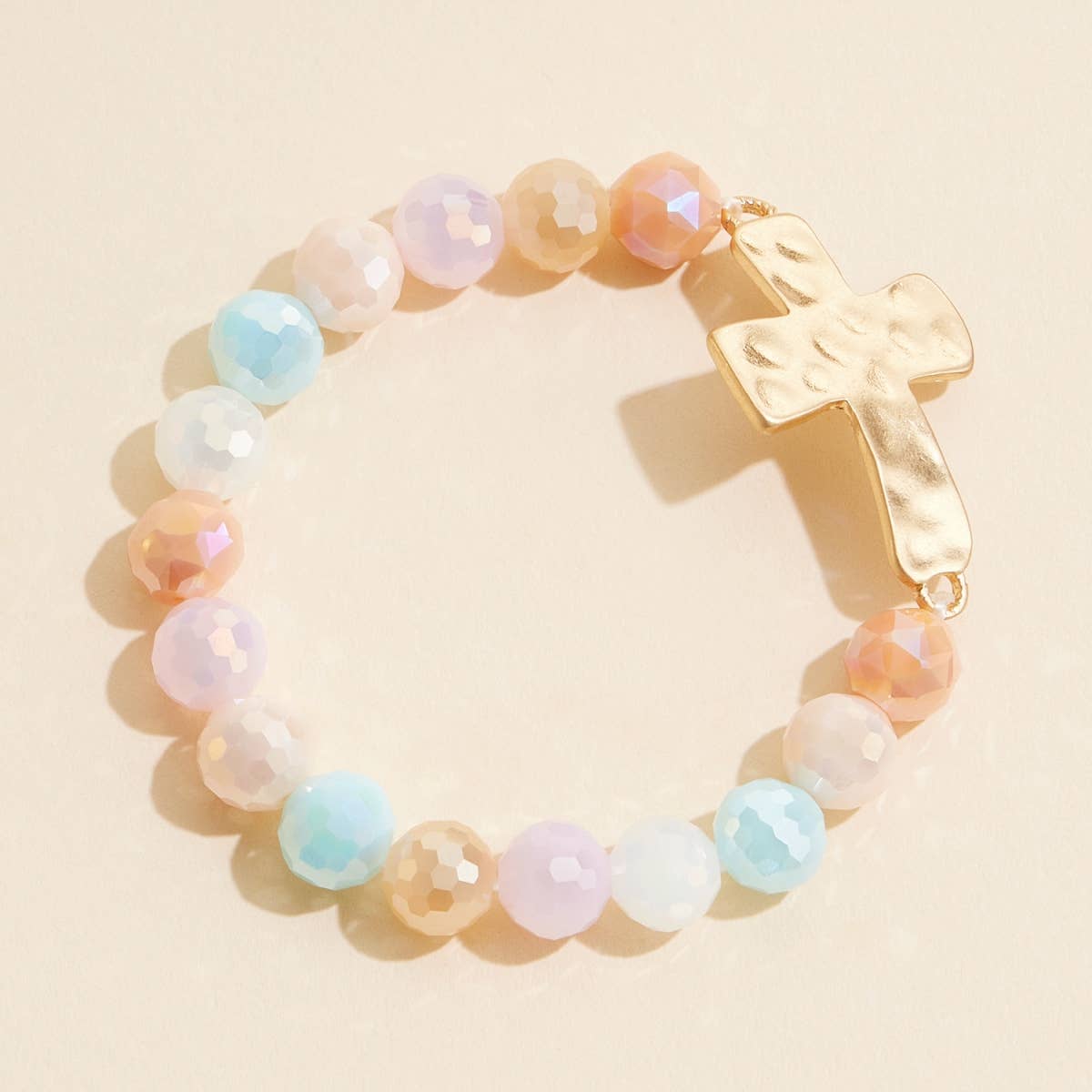 Pastel multicolor glass beaded stretch bracelet with hammered metal cross charm.