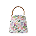 Bucket bag with colorful pagoda-inspired print featuring lanterns, bridges, palm trees, and willow trees with bamboo handle.