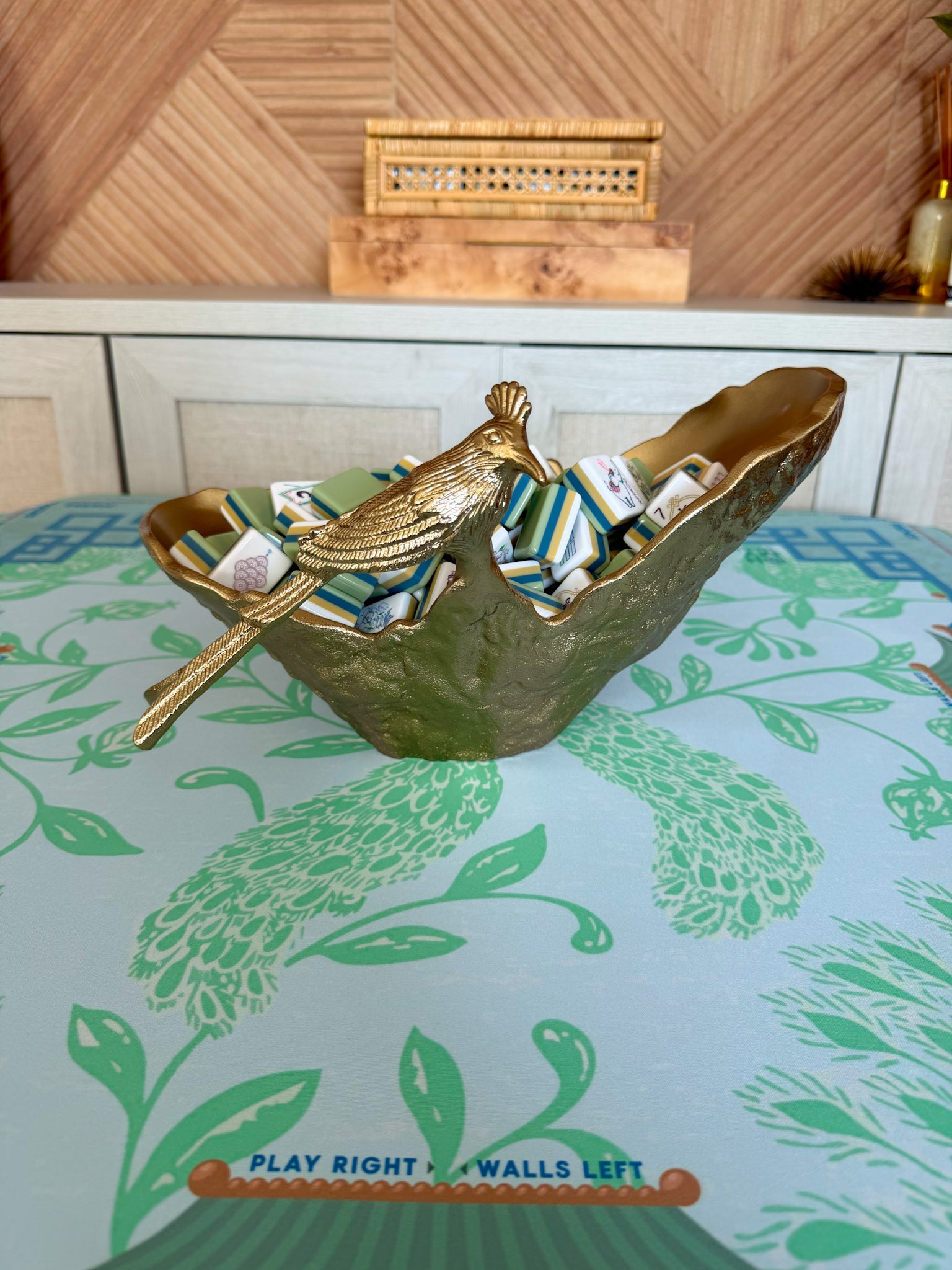 Created bird on a gold sculptural bowl holding mahjong tiles 