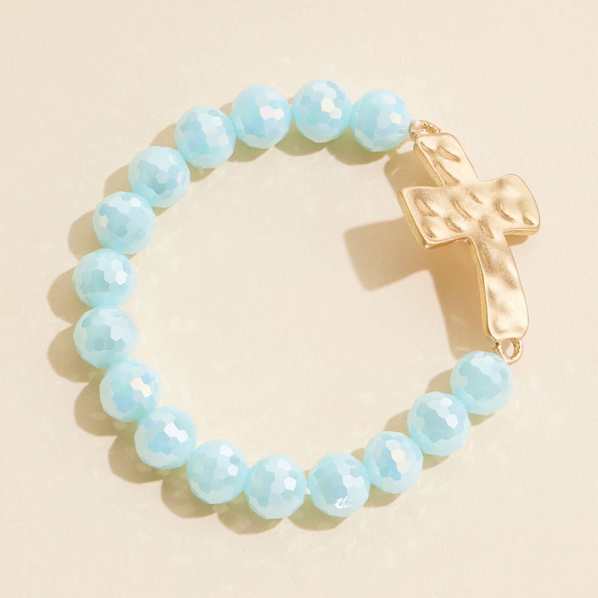 Mint glass beaded stretch bracelet with hammered metal cross charm.