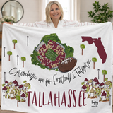 FSU-inspired white fleece blanket featuring Doak Campbell Stadium, tailgate tents, and garnet Tallahassee lettering