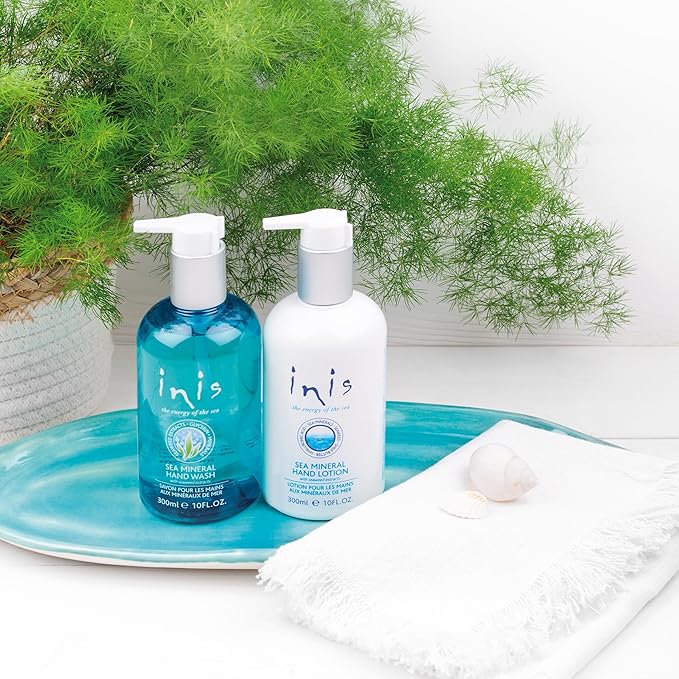 White metal caddy holding two 10 oz. bottles of Inis hand soap and hand lotion with coastal blue labels.