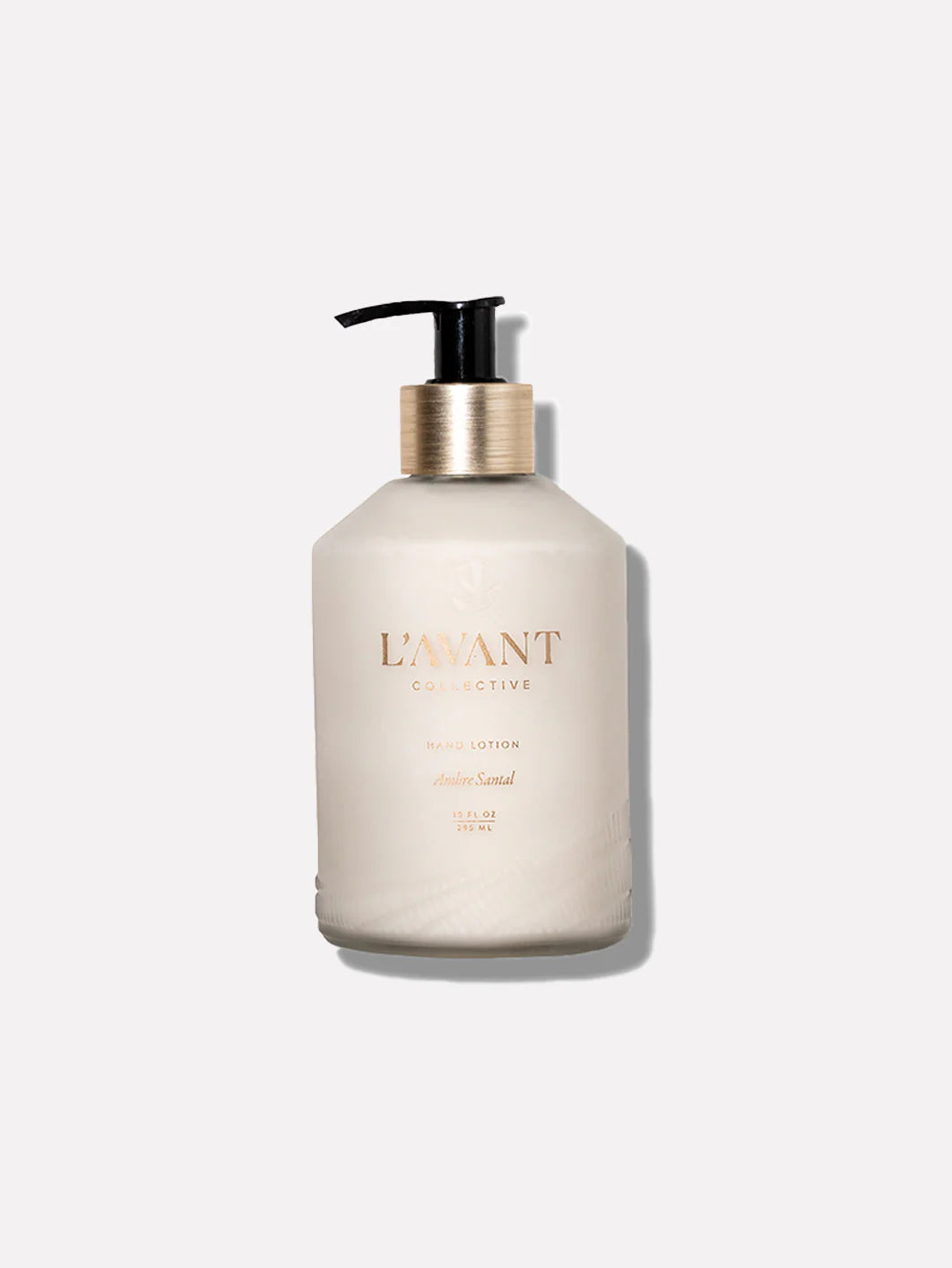Elegant glass bottle of L'AVANT Blushed Bergamot Hand Lotion with brushed gold pump and moisturizing plant-based formula.