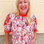 Abstract printed short sleeve blouse with embroidered sleeves and contrast trim