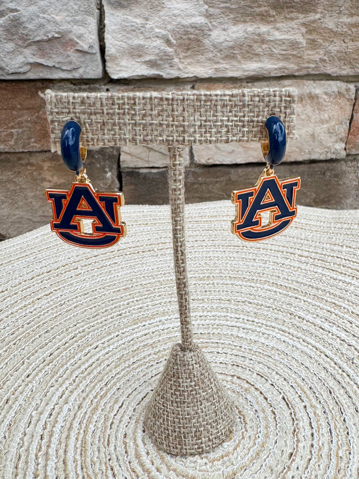 Auburn Tigers enamel logo huggie hoop earrings featuring navy team logo accents and shiny gold hoops.