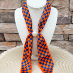 Auburn Tigers magnetic pearl scarf necklace featuring a silky orange and navy checkerboard scarf with a magnetic pearl clasp.