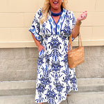 Blue and white printed midi dress with defined waist and flowy skirt