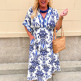 Blue and white printed midi dress with defined waist and flowy skirt