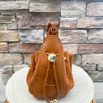 Camel faux suede slouchy shoulder bag with gold chain straps and drawstring-style closure.