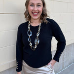 Black long sleeve knit top with button cuff details