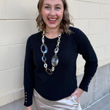 Black long sleeve knit top with button cuff details