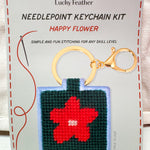 Red flower needlepoint keychain kit on dark green background