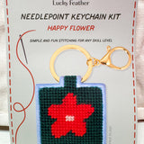 Red flower needlepoint keychain kit on dark green background