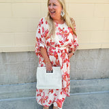 Cream midi dress with pink and orange floral print, scoop neckline, elastic waist, and flowy dolman sleeves.