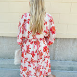 Cream midi dress with pink and orange floral print, scoop neckline, elastic waist, and flowy dolman sleeves.