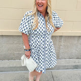 Navy floral dress with puff sleeves, button-down front, and collar