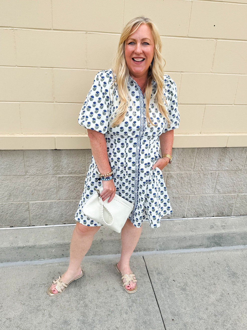 Navy floral dress with puff sleeves, button-down front, and collar