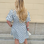 Navy floral dress with puff sleeves, button-down front, and collar