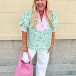 Green floral print caftan-style top with puff sleeves, split neckline, and lightweight fabric for effortless style.