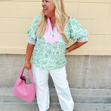 Green floral print caftan-style top with puff sleeves, split neckline, and lightweight fabric for effortless style.