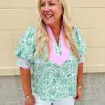 Green floral print caftan-style top with puff sleeves, split neckline, and lightweight fabric for effortless style.